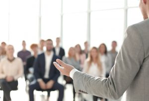 image of a speaker giving a lecture at a business seminar